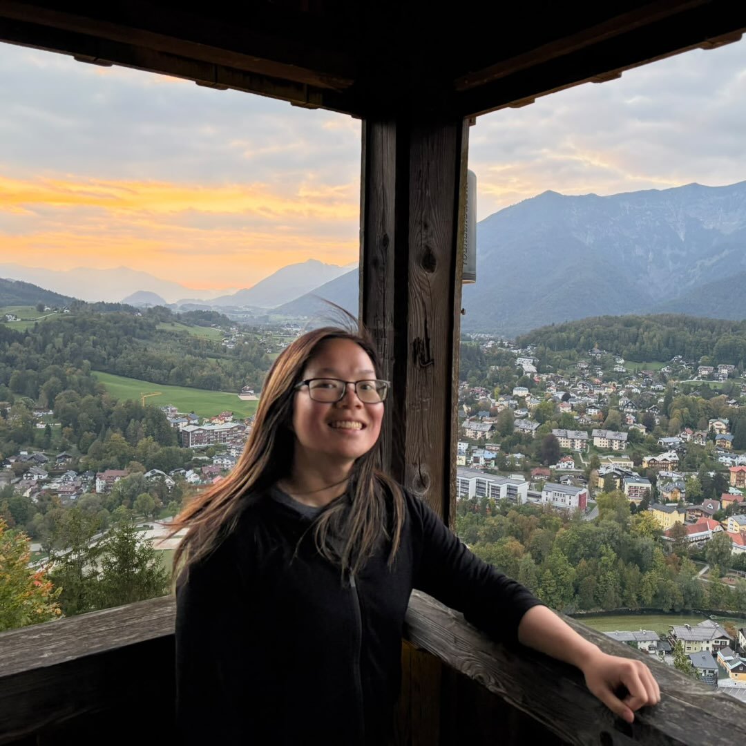 Christine smiling at a mountain overlook at sunset